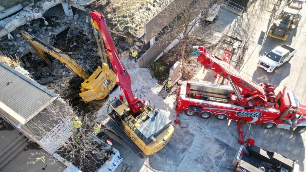 World’s Largest Rotator Tow Truck Called in After Excavator Falls Through Parking Garage